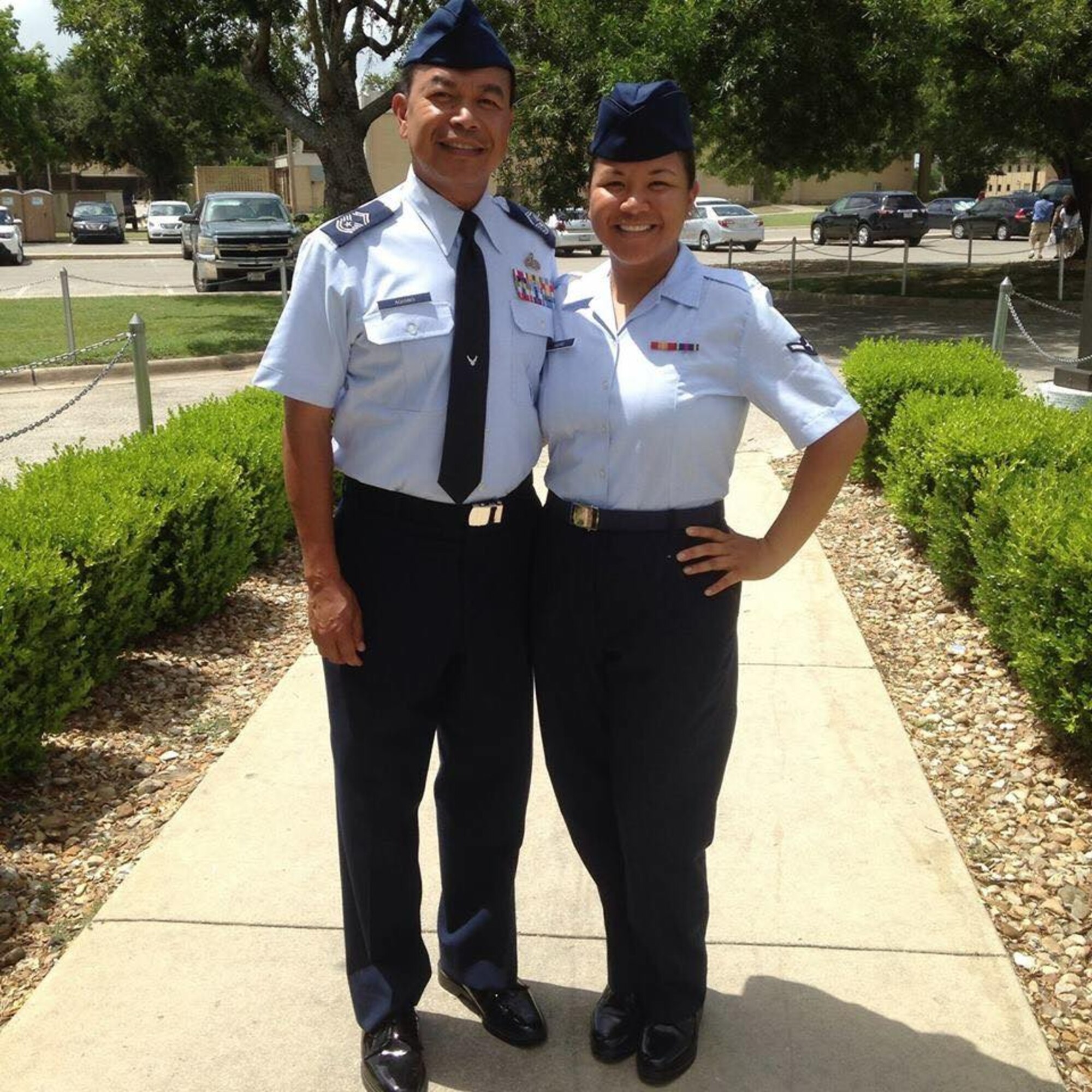 Andrea Aquino and her father Edwin Aquino pose for a photo after her basic military training graduation.