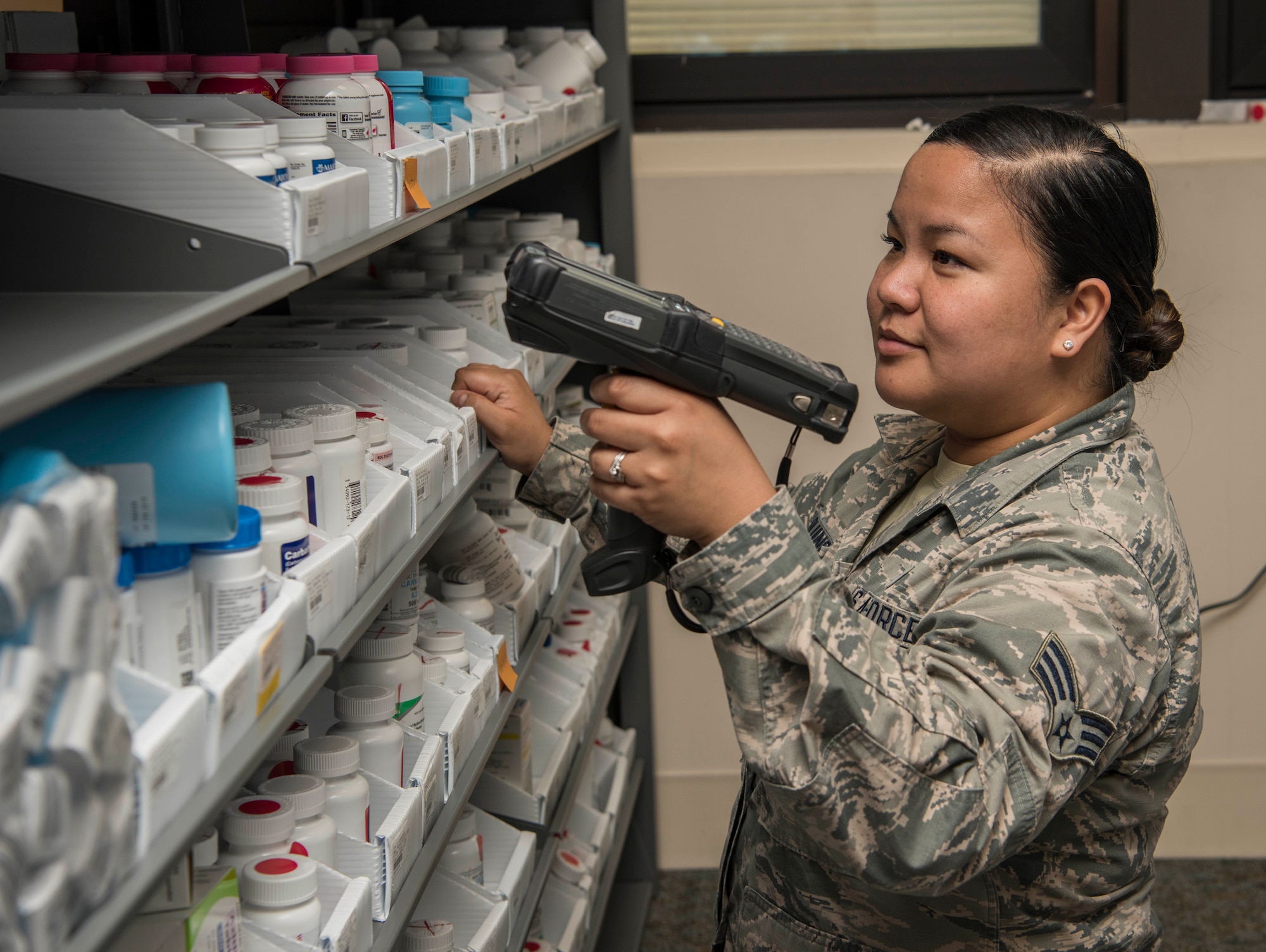 Senior Airman Andrea Aquino, 375th Medical Support Squadron pharmacy technician, scans a prescription May 29, 2018, Scott Air Force Base, Ill. Aquino's family has a long and proud tradition of serving in the United States military. (U.S. Air Force photo by Senior Airman Melissa Estevez)