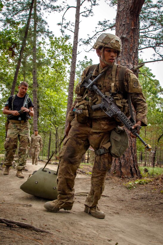 A soldier transports a role-playing casualty.