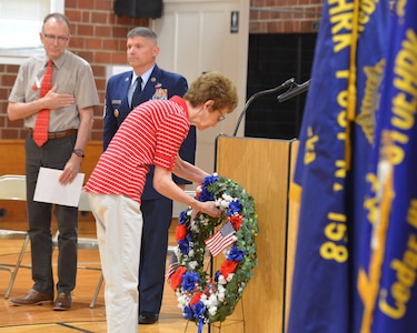 A member of Sons of the American Legion Post 158 Auxiliary lays a wreath during a Memorial Day ceremony at Cedar Bluff Auditorium in Cedar Bluff, Neb., May 28, 2018.