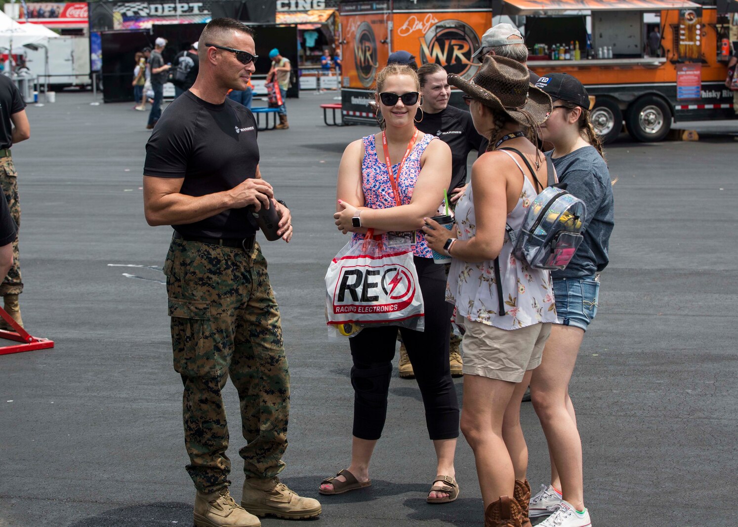 Major Jason G. Ellis, Commanding Officer of Recruiting Station Columbia, speaks to attendants of the Coca-Cola 600 at the Charlotte Motor Speedway on May 26, 2018. The Marines took part in the battles won challenge trailer at the Coca-Cola 600 NASCAR race to spread awareness of the opportunities that the Marine Corps can provide. (U.S. Marine Corps photo by Lance Cpl. Jack A. E. Rigsby)