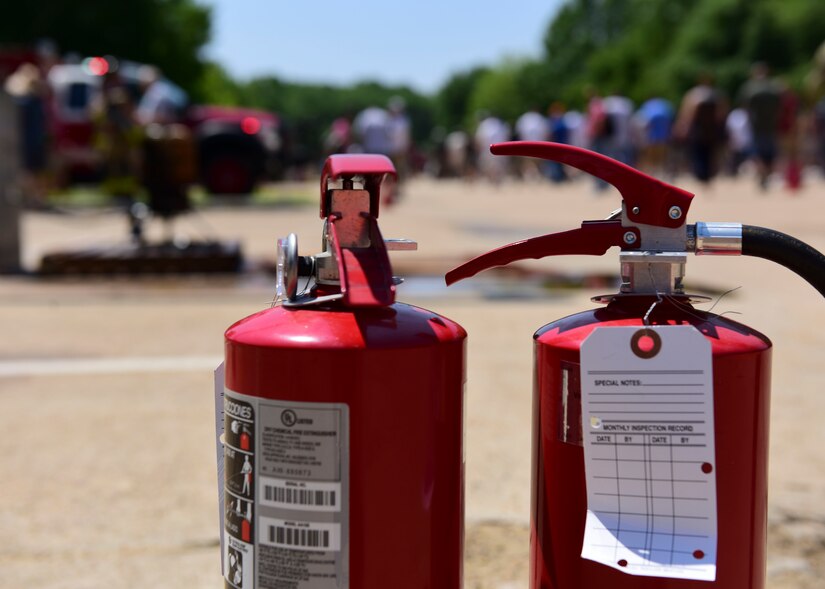 Fire extinguishers are kept close by during the deep-fried turkey demonstration for the 128th Aviation Brigade unit safety day at Joint Base Langley-Eustis, Virginia, May 24, 2018. Fire safety and proper fire extinguisher techniques were the main lessons throughout the day’s events. (U.S. Air Force photo by Airman 1st Class Monica Roybal)