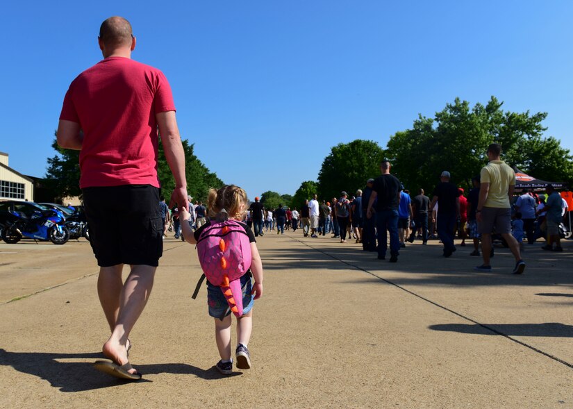 A U.S. Army Soldier walks with his daughter during the 128th Aviation Brigade Safety Day event at Joint Base Langley-Eustis, Virginia, May 24, 2018. The brigade encouraged families to attend and learn proper techniques to be applied at home. (U.S. Air Force photo by Airman 1st Class Monica Roybal)