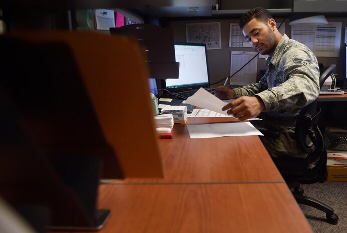 Senior Airman Jordan Guthrie, 437th Aerial Port Squadron passenger travel technician, processes paperwork here May 2, 2018. Guthrie was selected by his leadership to design art for a squadron mural. The mural highlights the “Port Dawgs” heritage, showcasing the squadron’s culture. Guthrie has been drawing and practicing art since he was 10 years old.