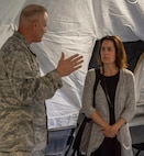 Air Force Lt. Col. Ronald Chastain, Current Operations Division chief, briefs Caroline Wadhams, senior advisor on national security and VA affairs for Senator Mark Warner (D-VA), on Early Entry Command Post operations during a visit to Joint Task Force Civil Support May 30. Wadhams and Zach Lewis, Defense legislative coordinator to Senator Warner, received briefings on command operations.  The briefings were conducted in the command's new
air beam tent, which inflates using air compressors built into the structure for faster set up. JTF-CS provides command and control for designated Department of Defense specialized response forces to assist local, state, federal and tribal partners in saving lives, preventing further injury, and providing critical support to enable community recovery.  (Official Department of Defense photo by Mass Communication Specialist 3rd Class Michael Redd)