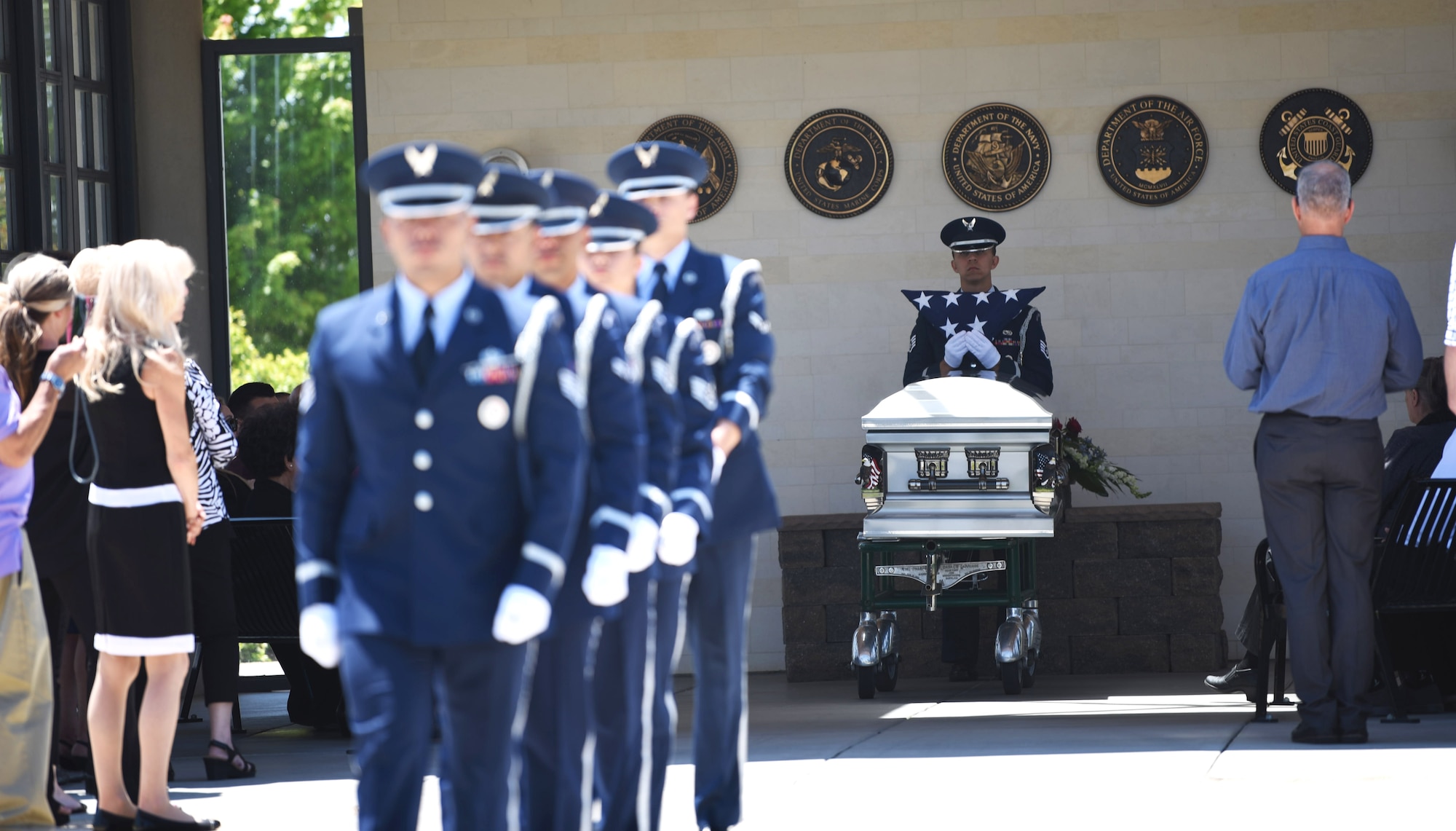 U.S. Air Force Staff Sgt. Steven C. Flynn, Travis Air Force Base Honor Guard lead instructor, stays behind other guardsmen to hand the flag to the next-of-kin May 22, 2018, at Sacramento Valley National Cemetery, Calif. Travis’ Honor Guard covers 45,000 sq. miles to include four National Commentaries, two VA’s and every private resting area between. (U.S. Air Force photo by Airman 1st Class Jonathon D. A. Carnell)