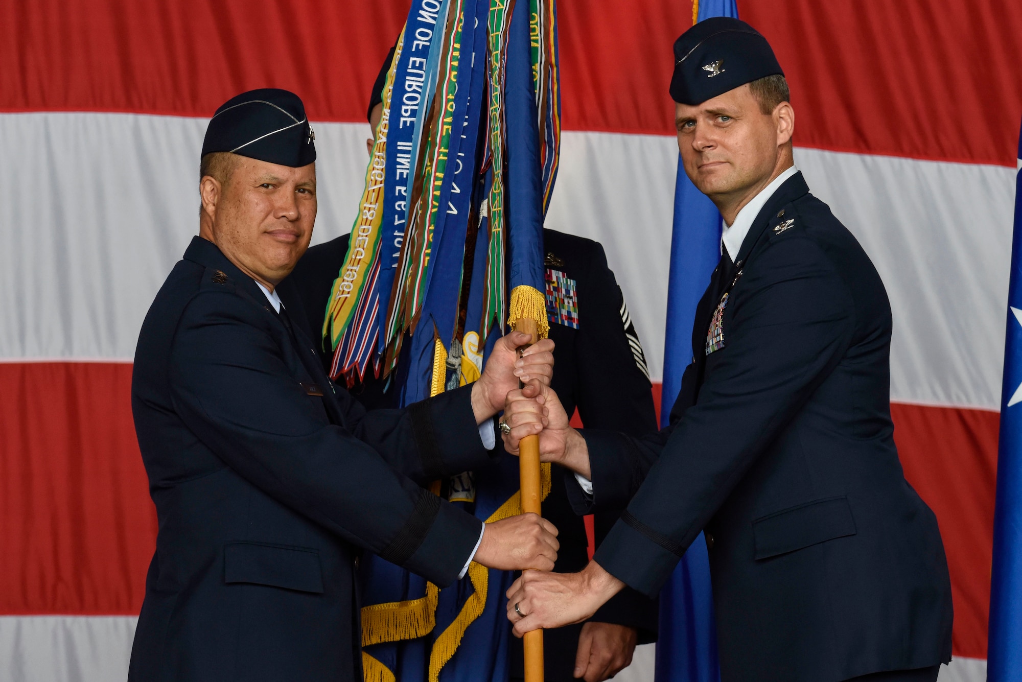 Lt. Gen. GI Tuck (left), 18th Air Force commander, presents the 436th Airlift Wing guidon to Col. Joel Safranek, incoming 436th AW commander, during a change of command ceremony May 30, 2018, at Dover Air Force Base, Del. During the ceremony, Safranek assumed command of the 436th AW becoming the wing’s 34th commander. (U.S. Air Force photo by Airman 1st Class Zoe M. Wockenfuss)