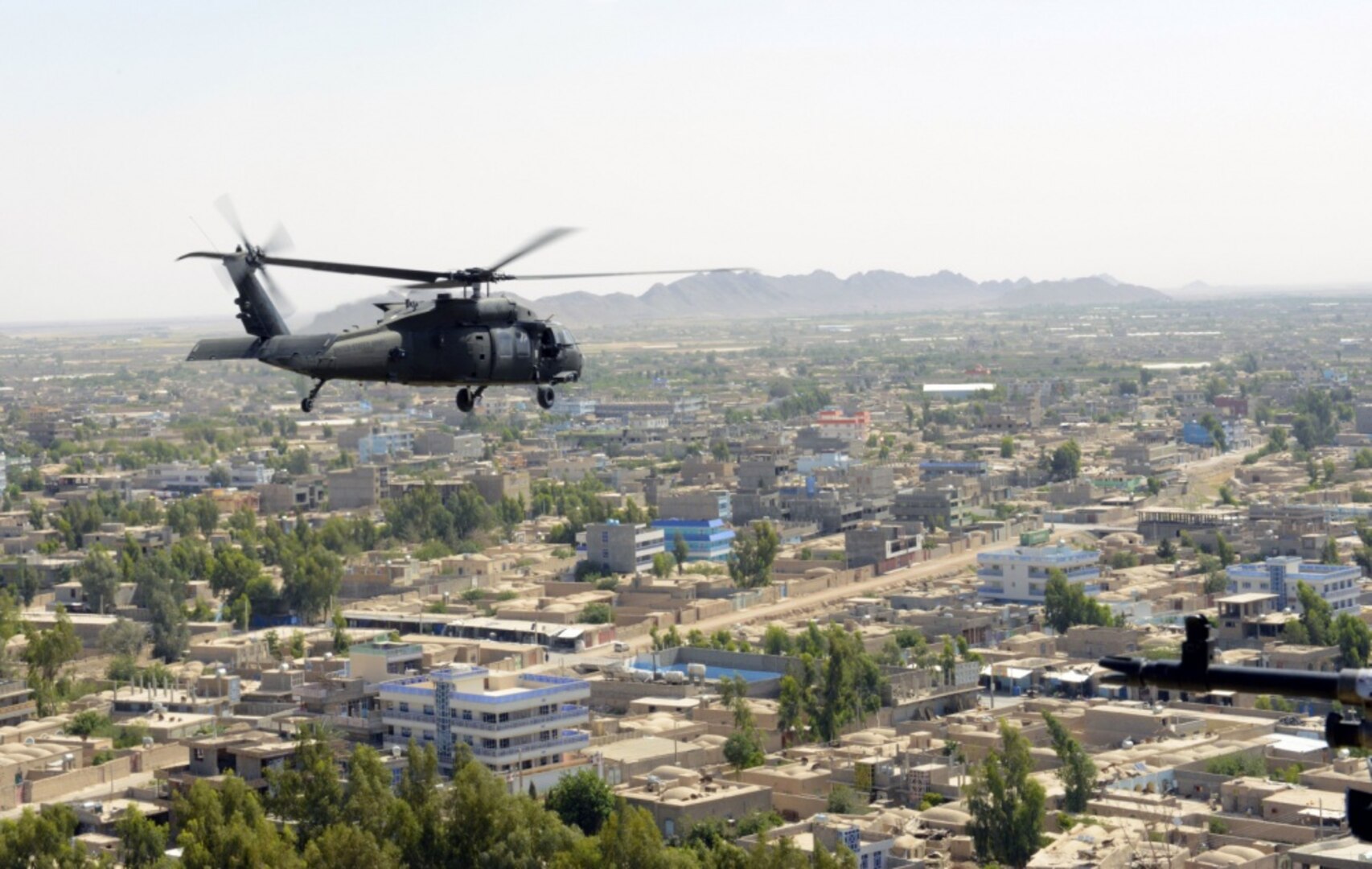 A U.S. Army UH-60 Black Hawk helicopter flies over Farah City, Afghanistan.