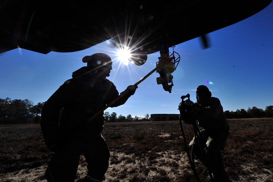 Airmen from the 818th Contingency Response Group, 621st Contingency Response Wing (CRW), Joint Base McGuire-Dix-Lakehurst, N.J., perform sling load training with a CH-53E Super Stallion transport helicopter assigned to Marine Heavy Helicopter Squadron 772 at JBMDL, Jan. 9, 2014. Rescue Airmen from the 23d Wing visited the Devil Raiders of the 621st CRW, May 21-23, to better understand the essential assets to stand up rescue operations from bare-base situations. (U.S. Air Force photo by Tech. Sgt. Parker Gyokeres)