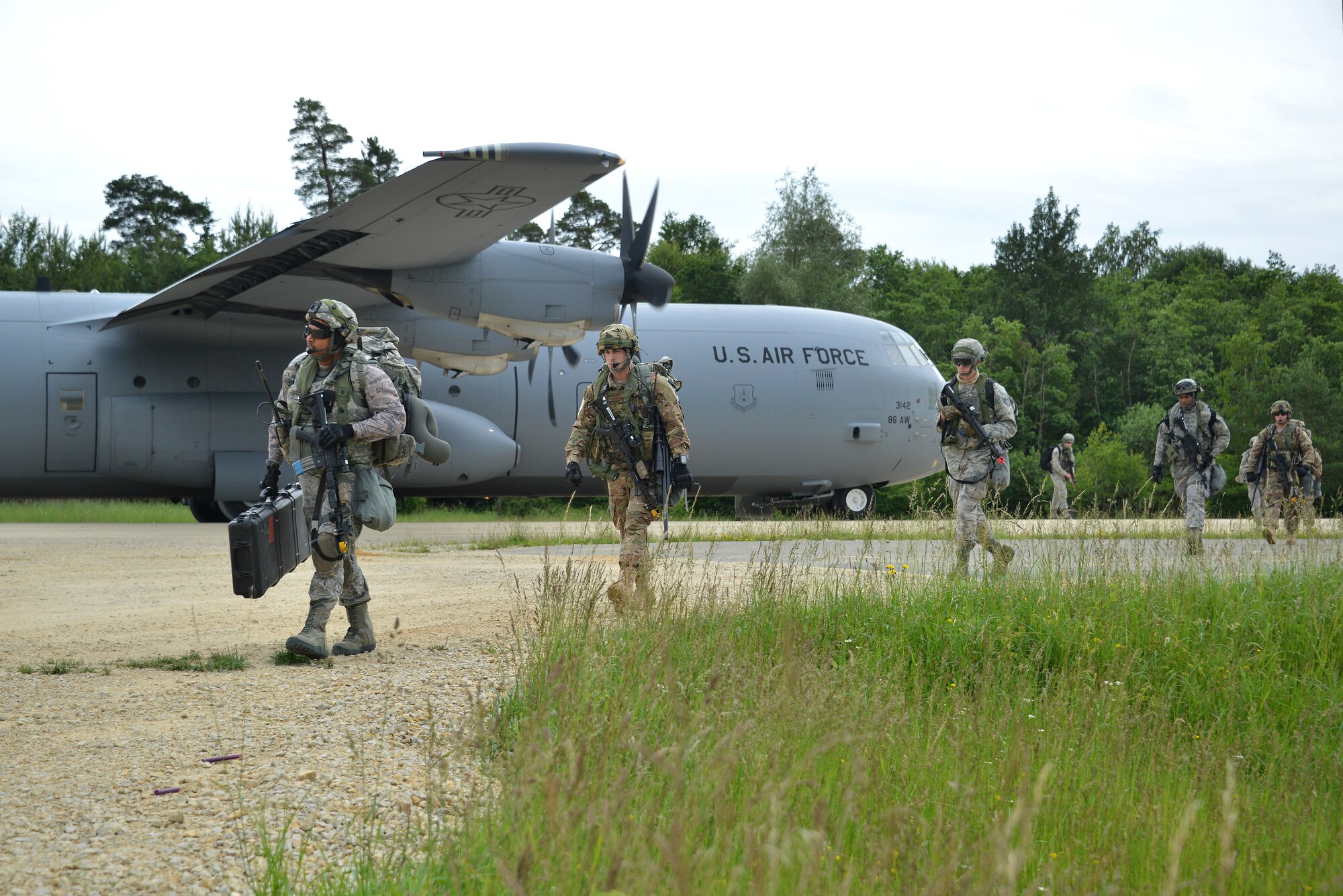 U.S. Airmen with the 621st Contingency Response Wing (CRW) dismount a C-130 Hercules during air-land operations at the Hohenfels Training Area (Germany) in support of Swift Response 16, June 16, 2016.Rescue Airmen from the 23d Wing visited the Devil Raiders of the 621st Contingency Response Wing, May 21-23, to better understand the essential assets to stand up rescue operations from bare-base situations. (U.S. Army photo by Visual Information Specialist Gertrud Zach/released)