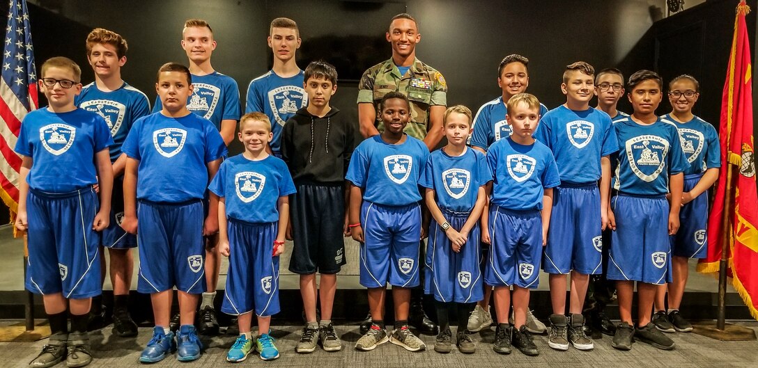 Tyson Henry (Center), a Summer Leadership and Character Developement Acadamy selectee, stands with his Young Marine troops on My 22, 2018. Henry will be joined by over 190 selectees from around the country who sought out this leadership challenge.