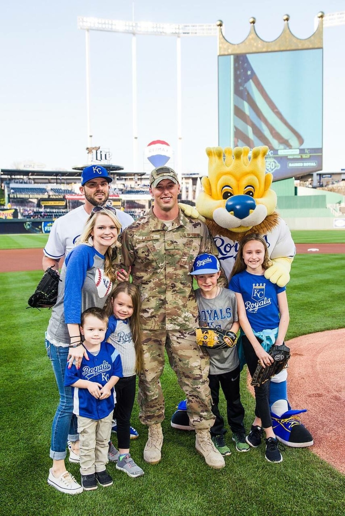 U.S. Air Force Tech. Sgt. Sean Laffey, armament specialist, assigned to the 442d Maintenance Squadron, holds his daughter as his family runs to welcome him home at Kauffman Stadium, Kansas City, Mo., May 19, 2018.