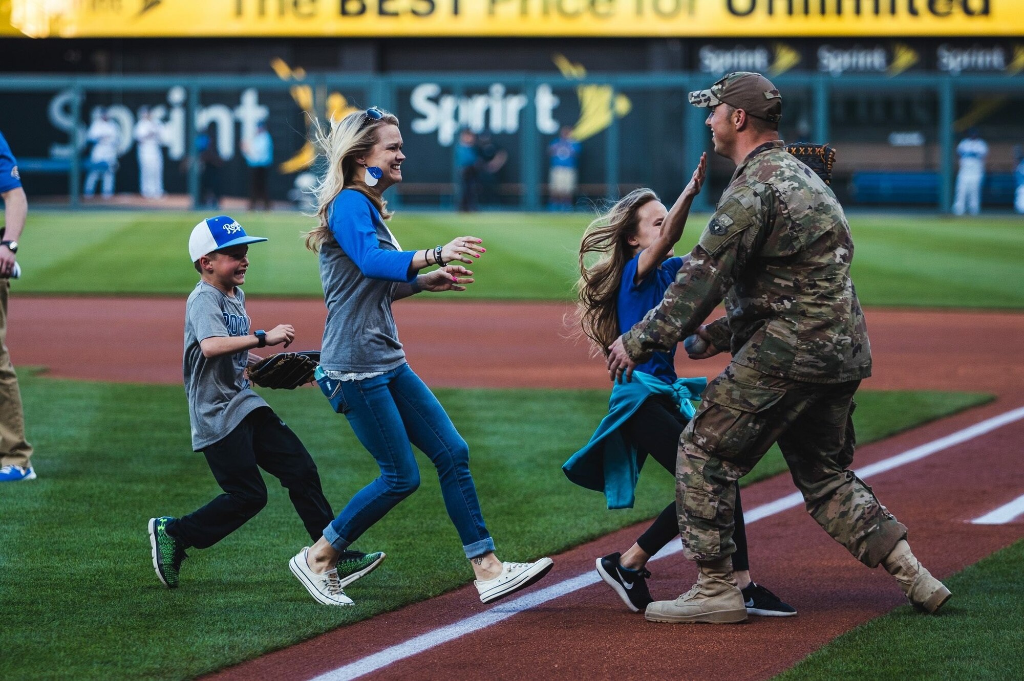 U.S. Air Force Tech. Sgt. Sean Laffey, armament specialist, assigned to the 442d Maintenance Squadron, hugs his family during his surprise homecoming at Kauffman Stadium, Kansas City, Mo., May 19, 2018.