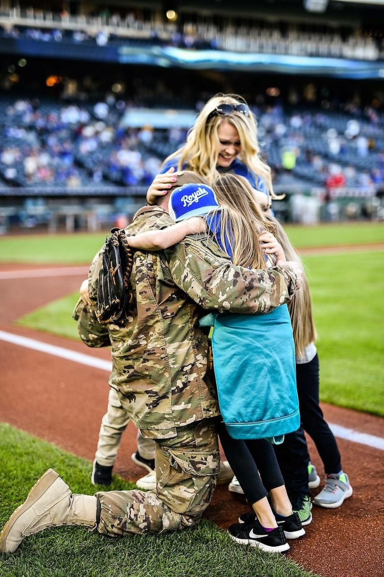 The Laffey family poses with the Kansas City Royals’ third-baseman Mike Moustakas and the Royals’ mascot during a surprise homecoming at Kauffman Stadium, Kansas City, Mo., May 19, 2018.