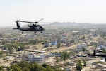 A helicopter flies over a city.