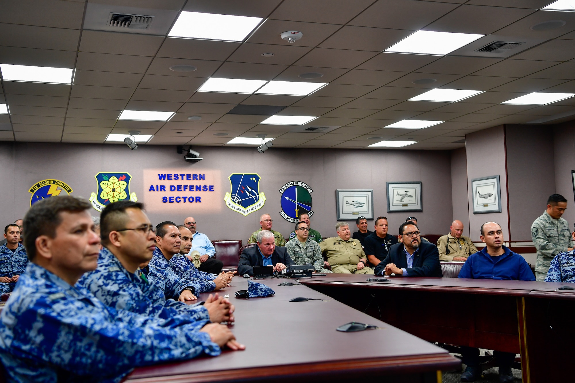 AMALGAM EAGLE 18 exercise planners from the Mexican Air Force, U.S. Air Force, Air National Guard, U.S. Customs and Border Protection, and U.S. Army receive a Western Air Defense Sector mission briefing May 22, 2018.  AMALGAM EAGLE 18 is a tactical exercise which is designed to enhance mutual warning and information sharing procedures in support of a cooperative response to illicit flights that cross the U.S.-Mexico border.