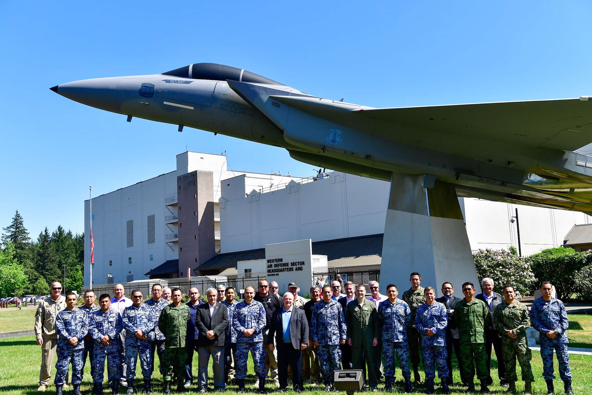 AMALGAM EAGLE 18 exercise planners take a group photo in front of the Western Air Defense Sector Air Park May 22, 2018.  AMALGAM EAGLE 18 is a tactical exercise which is designed to enhance mutual warning and information sharing procedures in support of a cooperative response to illicit flights that cross the U.S.-Mexico border.