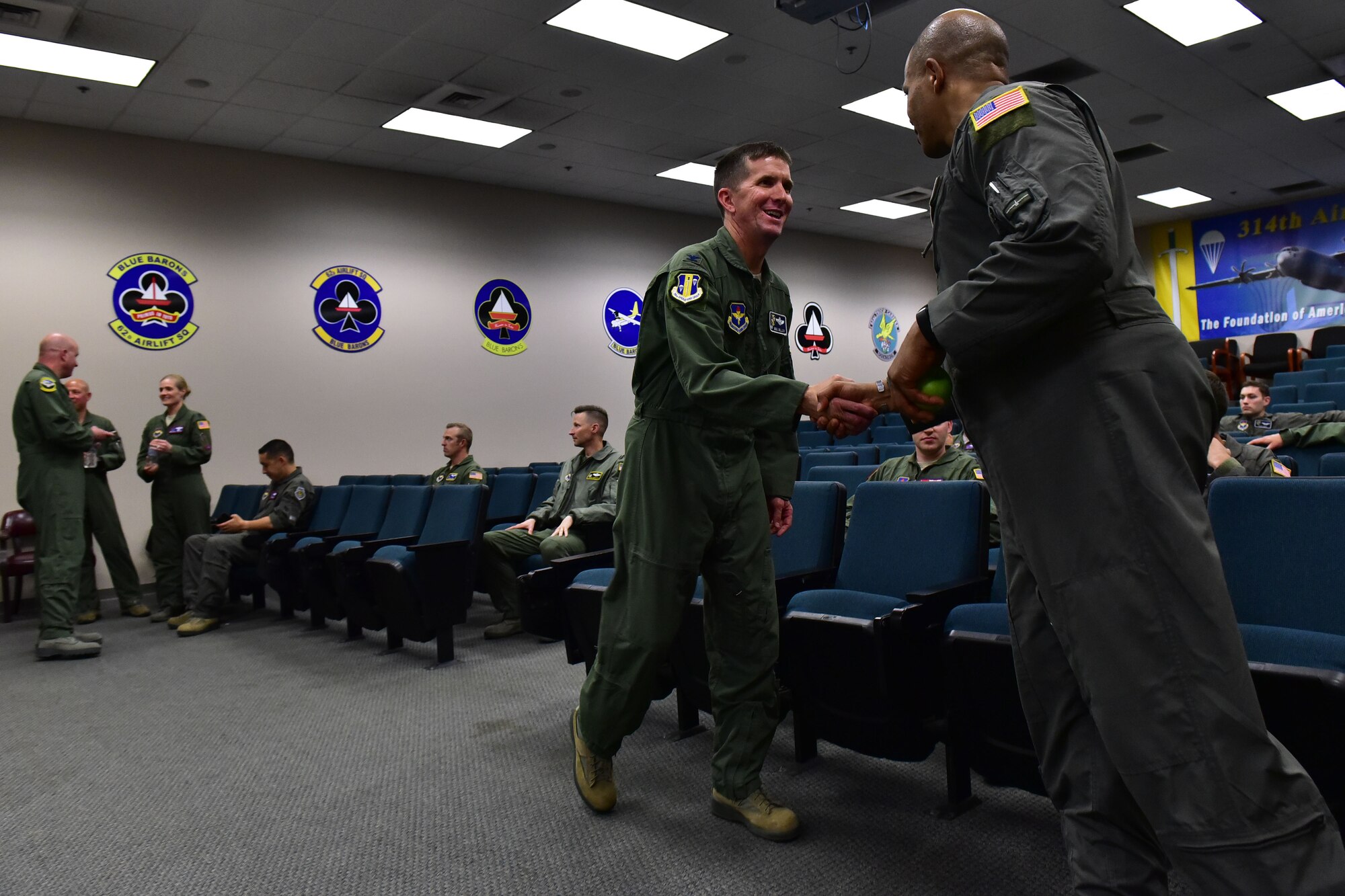 Airmen meet each other and prepare for a briefing.