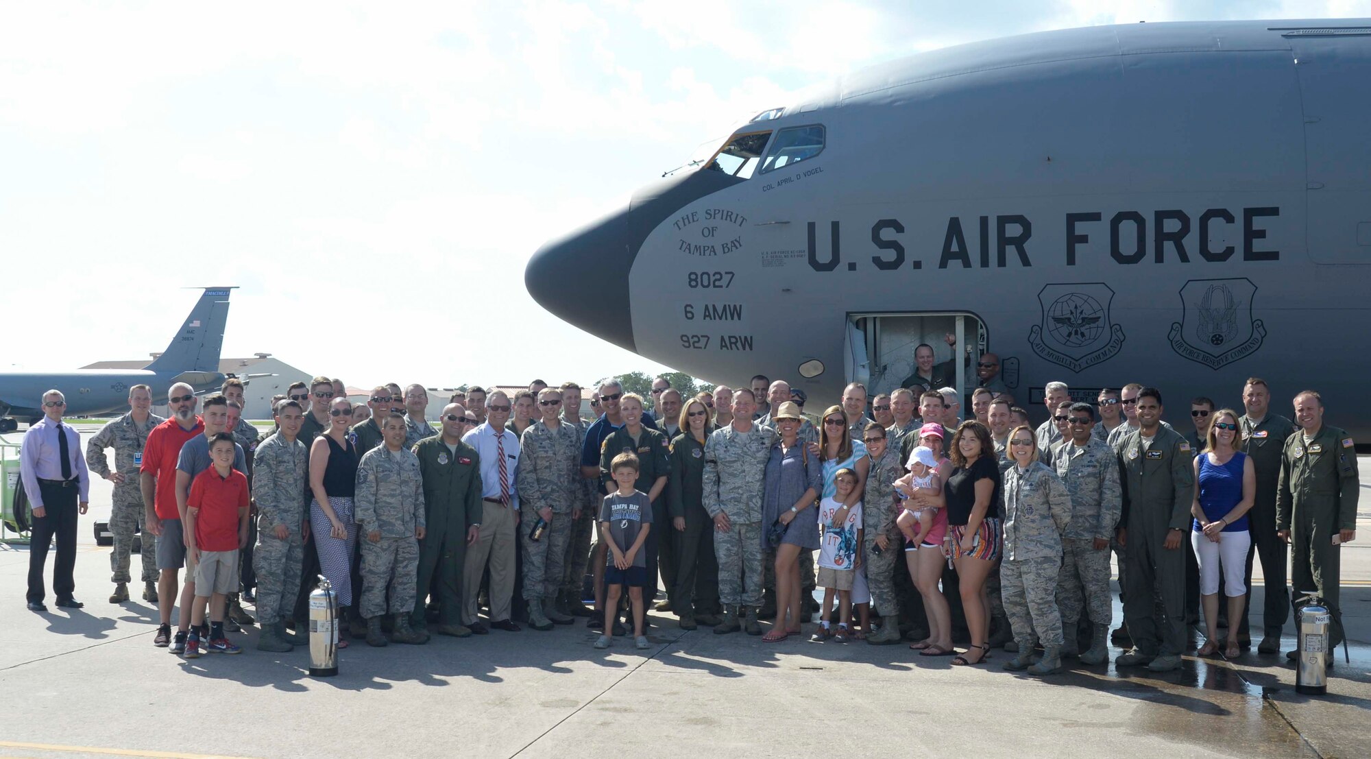 U.S. Air Force Airmen and family members pause for a photo after Col. April Vogel’s, commander of the 6th Air Mobility Wing (AMW), fini flight at MacDill Air Force Base, Fla., May 24, 2018. Personnel, family members, and friends came out to celebrate Vogel’s final flight as the 6th AMW commander.