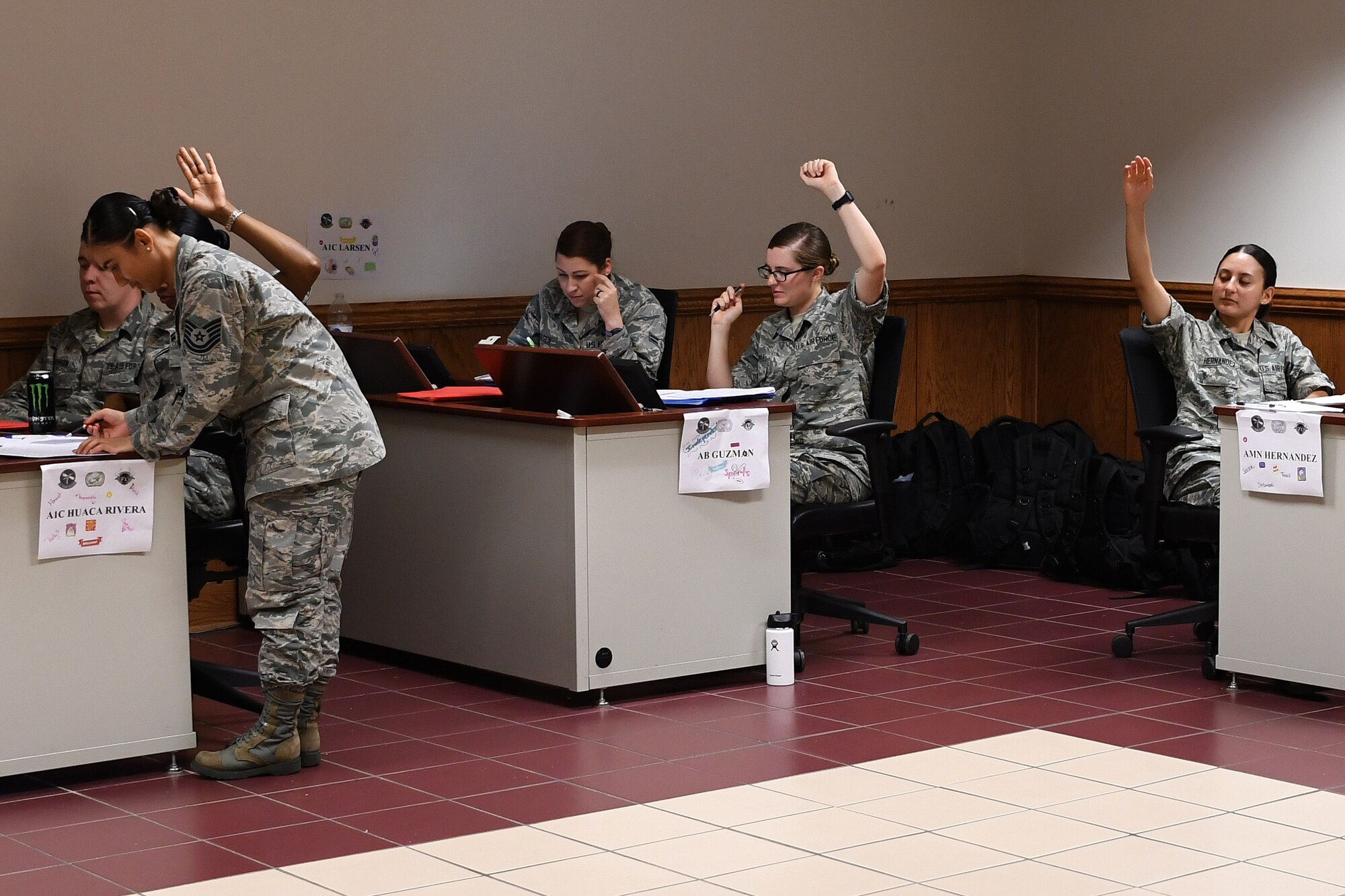 U.S. Air Force Tech. Sgt. Michelle Kautz, 335th Training Squadron Personnel Apprentice Course NCO in charge, checks a student’s work during a progress check at Keesler Air Force Base, Mississippi, May 24, 2018. The PAC students have to complete progress checks so the instructors can see what material the students struggle with during the five-week course. (U.S. Air Force photo by Airman 1st Class Suzie Plotnikov)