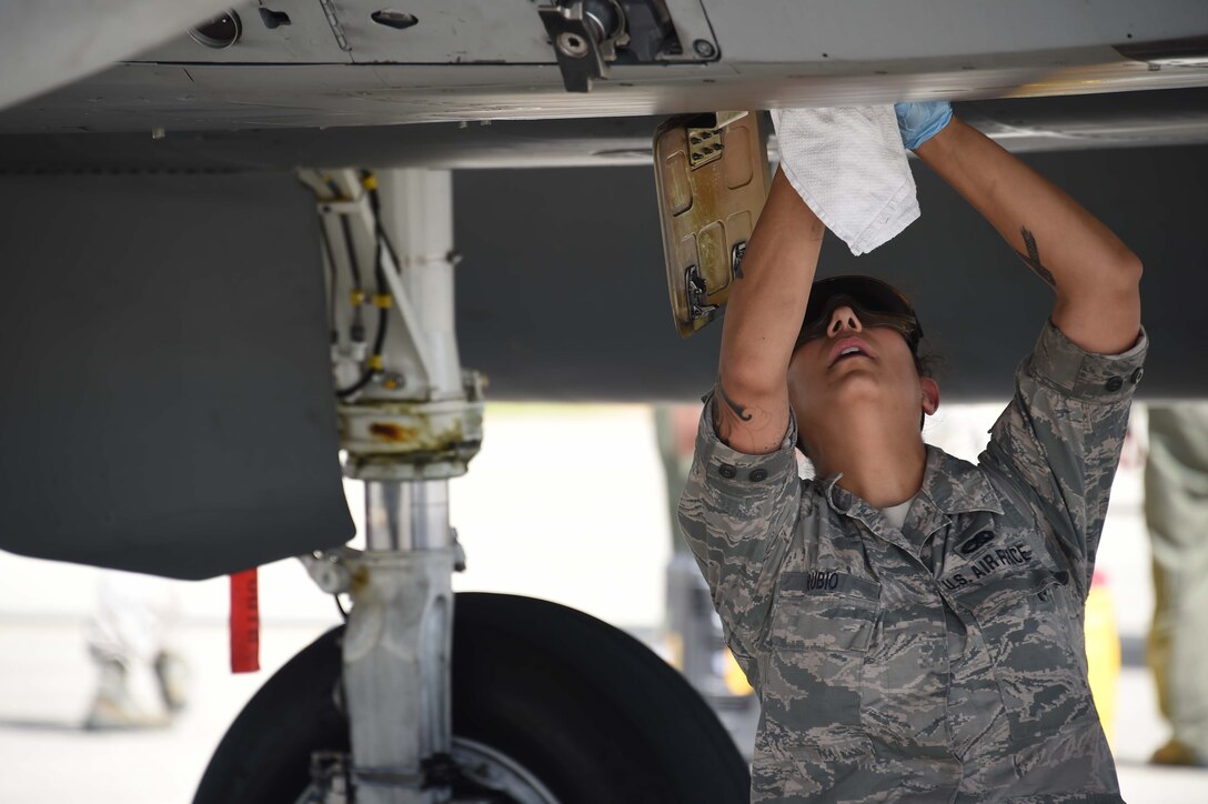U.S. Air Force Staff Sgt. Amanda Rubio, 144th Aircraft Maintenance Squadron crew chief, draws an oil sample after an F-15C Eagle fighter jet sortie during Sentry Aloha 18-01 Jan. 8, 2018 at Joint Base Pearl Harbor-Hickam, Hawaii.