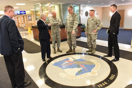 U.S. Air Force Gen. John Hyten (center right), commander of U.S. Strategic Command (USSTRATCOM), shows Sen. Jack Reed of Rhode Island (second from left), ranking member of the Senate Armed Services Committee, and Lt. Gen. Jack Weinstein (center left), Air Force chief of staff for strategic deterrence and nuclear integration, the command seal of Strategic Air Command (SAC) – the U.S. Air Force Major Command that evolved into USSTRATCOM – in the lobby of USSTRATCOM headquarters at Offutt Air Force Base, Neb., May 30, 2018.