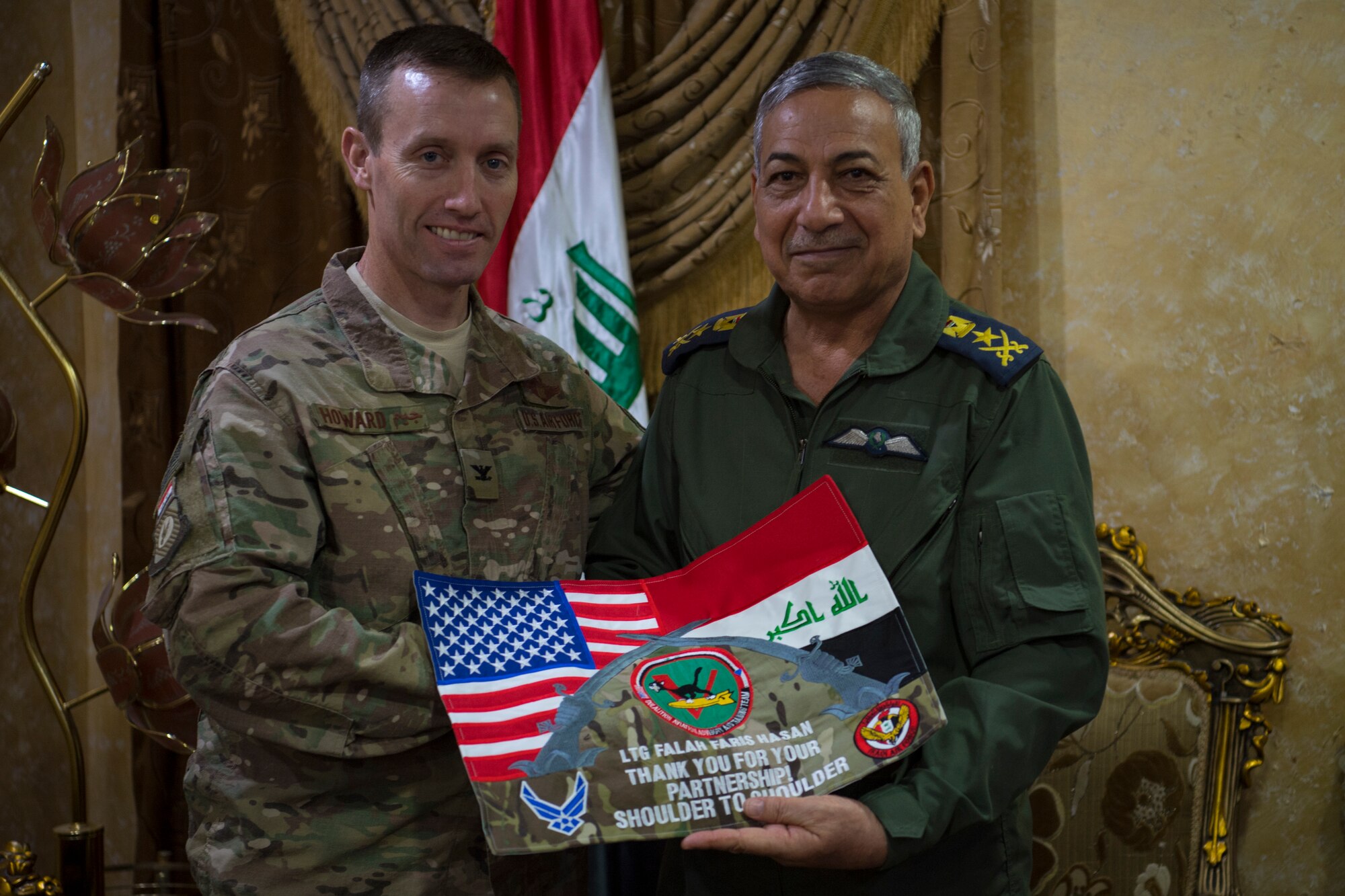U.S. Air Force Col. James Howard, 370th Air Expeditionary Advisory Group commander, presents Lt. Gen. Falah Hassan, Iraqi Air Force Deputy Commander, with a token of appreciation May 24, 2018, in Baghdad Iraq. Howard and Hassan worked closely together during Howards one year deployment. (U.S. Air Force photo by Staff Sgt. Joshua King)