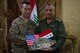 U.S. Air Force Col. James Howard, 370th Air Expeditionary Advisory Group commander, presents Lt. Gen. Falah Hassan, Iraqi Air Force Deputy Commander, with a token of appreciation May 24, 2018, in Baghdad Iraq. Howard and Hassan worked closely together during Howards one year deployment. (U.S. Air Force photo by Staff Sgt. Joshua King)