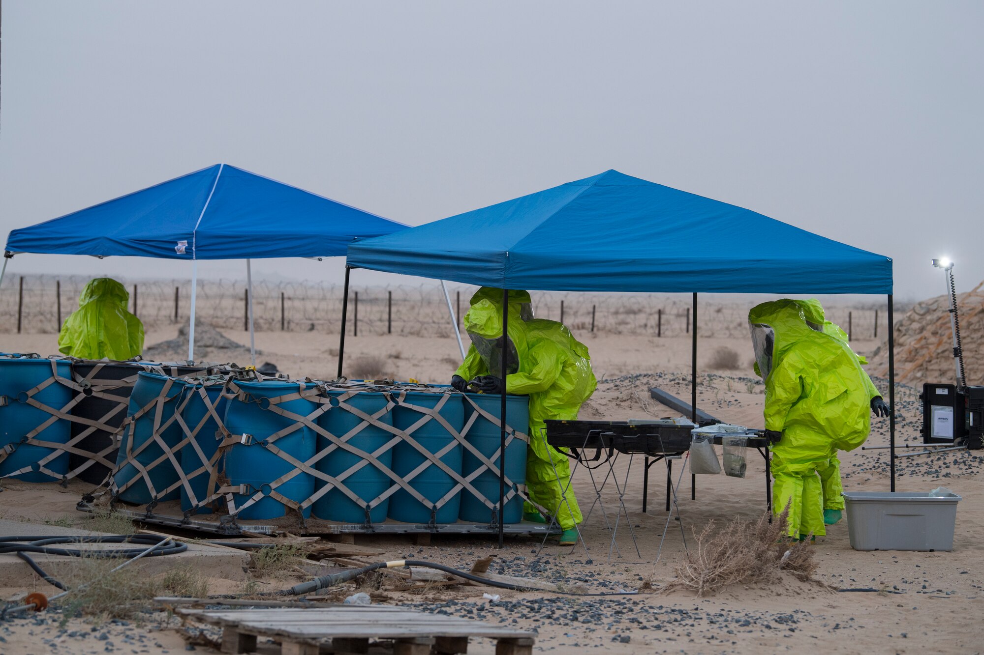 Airmen from the 386th Expeditionary Civil Engineer Squadron emergency management office, respond to hazardous materials at an undisclosed location in Southwest Asia, May 30, 2018. The team sampled 19 unknown barrels over 2 days. (U.S. Air Force photo by Staff Sgt. Joshua King)