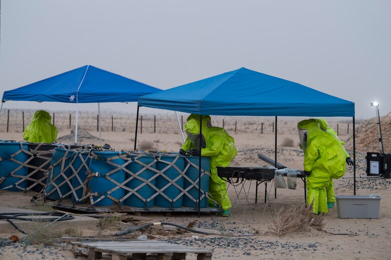 Airmen from the 386th Expeditionary Civil Engineer Squadron emergency management office, respond to hazardous materials at an undisclosed location in Southwest Asia, May 30, 2018. The team sampled 19 unknown barrels over 2 days. (U.S. Air Force photo by Staff Sgt. Joshua King)