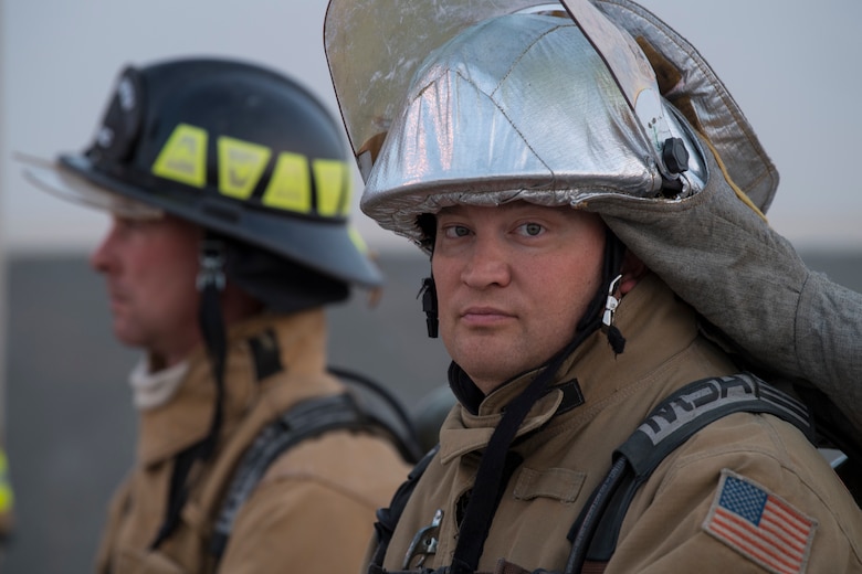 Firefighters from the 386th Expeditionary Civil Engineer Squadron, watch a hazardous materials examination to ensure the safety of those involved at an undisclosed location in Southwest Asia, May 30, 2018. The firefighters were there in case anything went wrong. (U.S. Air Force photo by Staff Sgt. Joshua King)