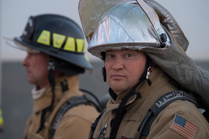 Firefighters from the 386th Expeditionary Civil Engineer Squadron, watch a hazardous materials examination to ensure the safety of those involved at an undisclosed location in Southwest Asia, May 30, 2018. The firefighters were there in case anything went wrong. (U.S. Air Force photo by Staff Sgt. Joshua King)