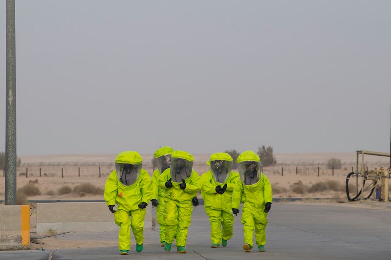 Airmen from the 386th Expeditionary Civil Engineer Squadron emergency management office walk to a decontamination site after responding to hazardous materials at an undisclosed location in Southwest Asia, May 30, 2018. The team found materials used to remove rubber from the runway. (U.S. Air Force photo by Staff Sgt. Joshua King)