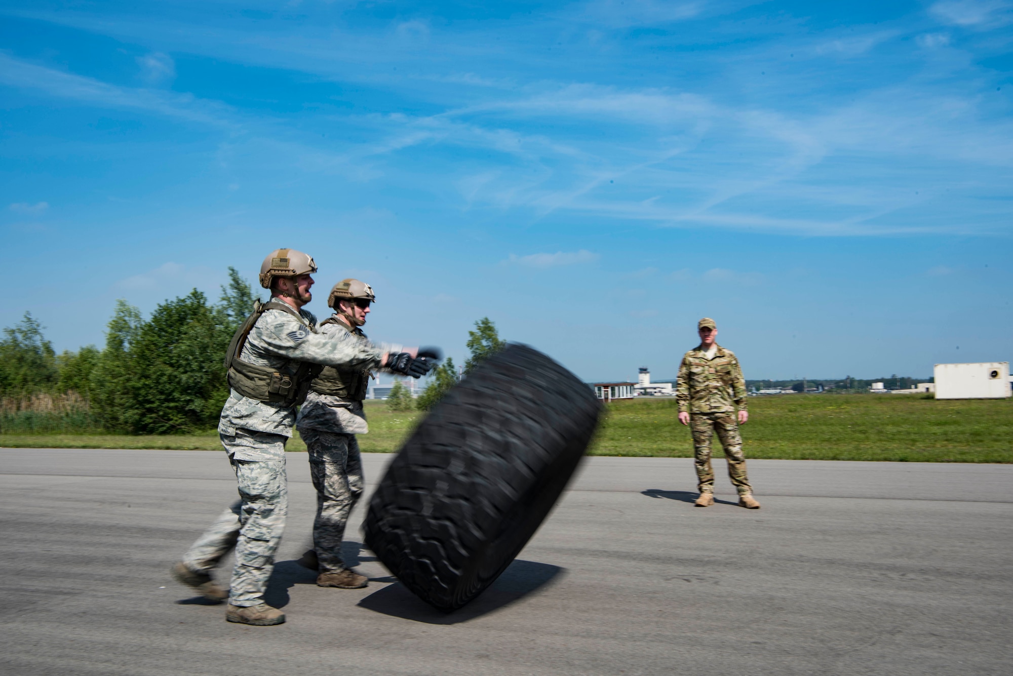 Members of the 435th Contingency Response Group participate in tire flips as part of the obstacle course in the 435th CRG Olympics, which included pushing a Humvee several hundred meters and a 100 meter bear crawl, on Ramstein Air Base, Germany, May 18, 2018. The 435th CRG Olympics provided an opportunity to practice all of their operations in a unique and friendly competition, leaving every Airman with a new appreciation for how their group accomplishes the mission.
