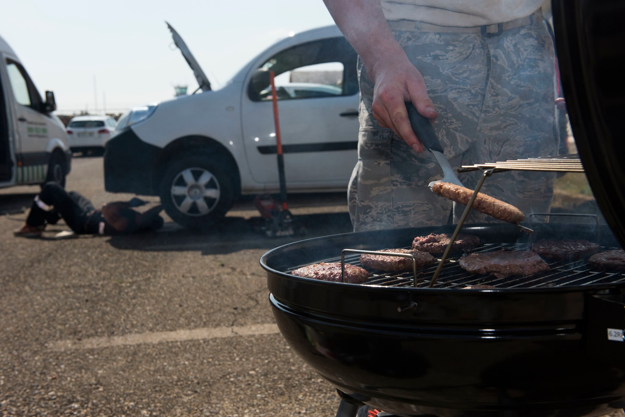 A U.S. Air Force Airman deployed to the 351st Expeditionary Air Refueling Squadron barbeques during a resiliency event at Zaragoza, Spain, May 24, 2018. Team Mildenhall’s community support coordinator established the 100th Aircraft Maintenance Squadron deployed resiliency training for Airmen in the deployed environment. (U.S. Air Force photo by Airman 1st Class Alexandria Lee)