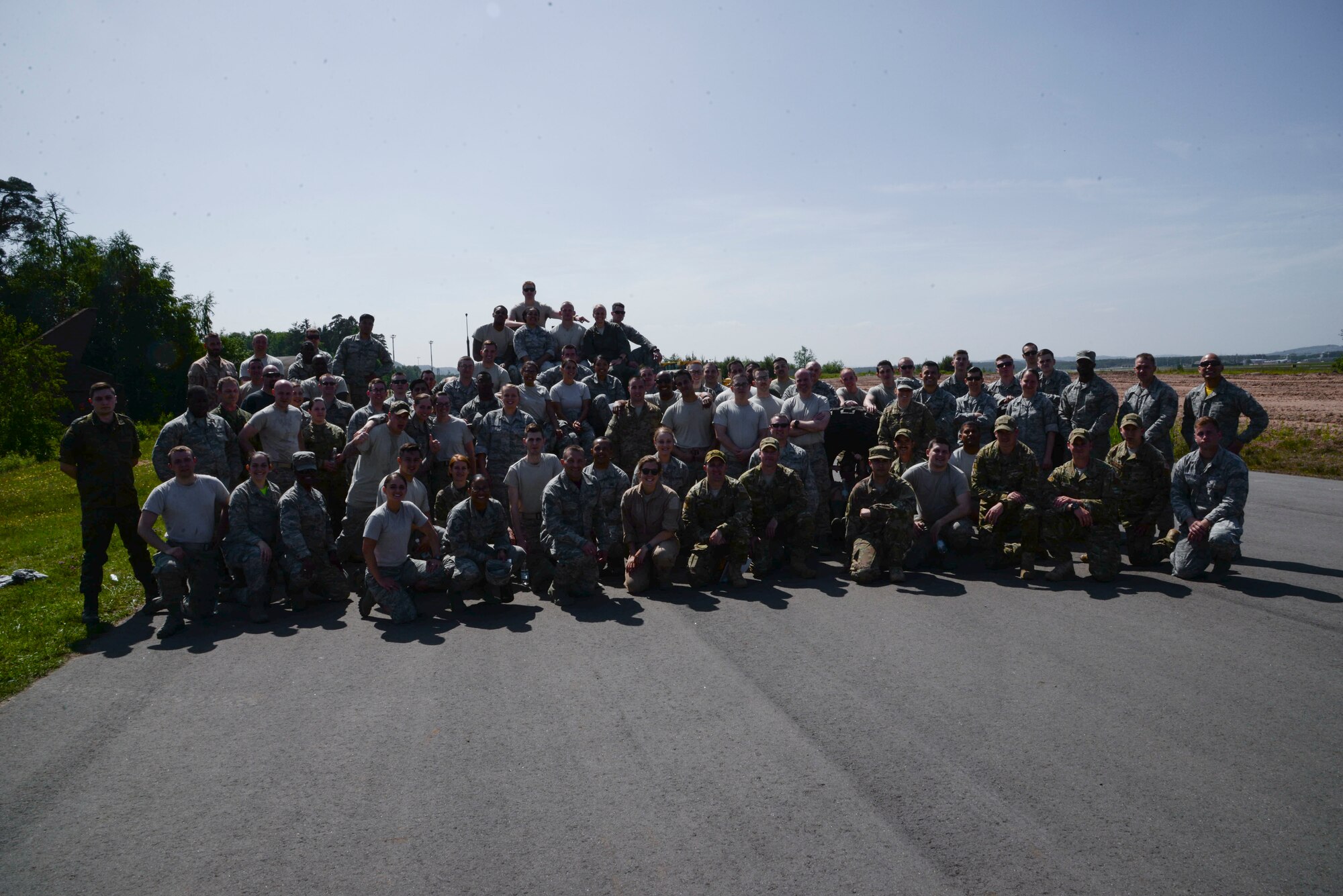 Atlantic Stripe Conference participants pose for a group photo after an obstacle course on Ramstein Air Base, Germany, May 18, 2018. The Airmen were selected to attend the conference because of their potential to serve in higher leadership positions as they continue throughout their careers. (U.S. Air Force photo by Airman 1st Class D. Blake Browning)