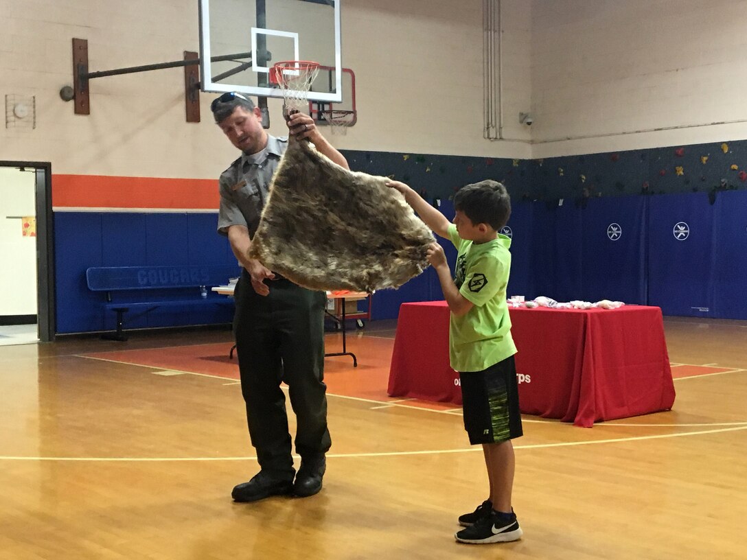 Park Ranger Dean Austin lets a student hold an animal pelt at West Cheatham Elementary School May 22, 2018 on Environmental Awareness Day. (Photo by Jessica Church)
