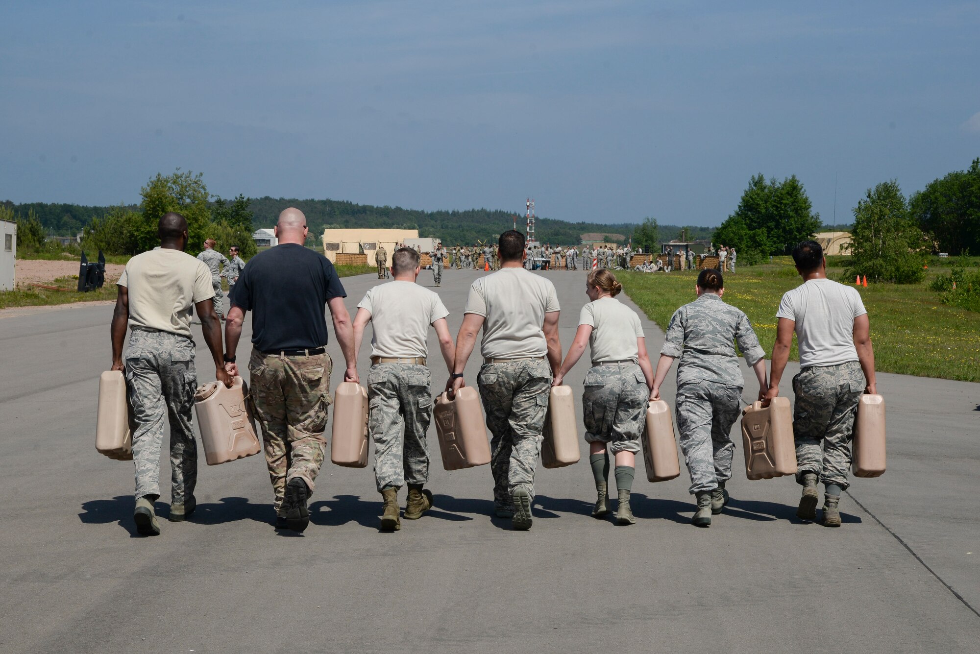 Atlantic Stripe Conference participants carry water containers as part of an obstacle course on Ramstein Air Base, Germany, May 18, 2018. With an emphasis on teamwork, leadership, and physical readiness, the obstacle course concluded the week-long conference aimed at deliberately developing noncommissioned officers. (U.S. Air Force photo by Airman 1st Class D. Blake Browning)