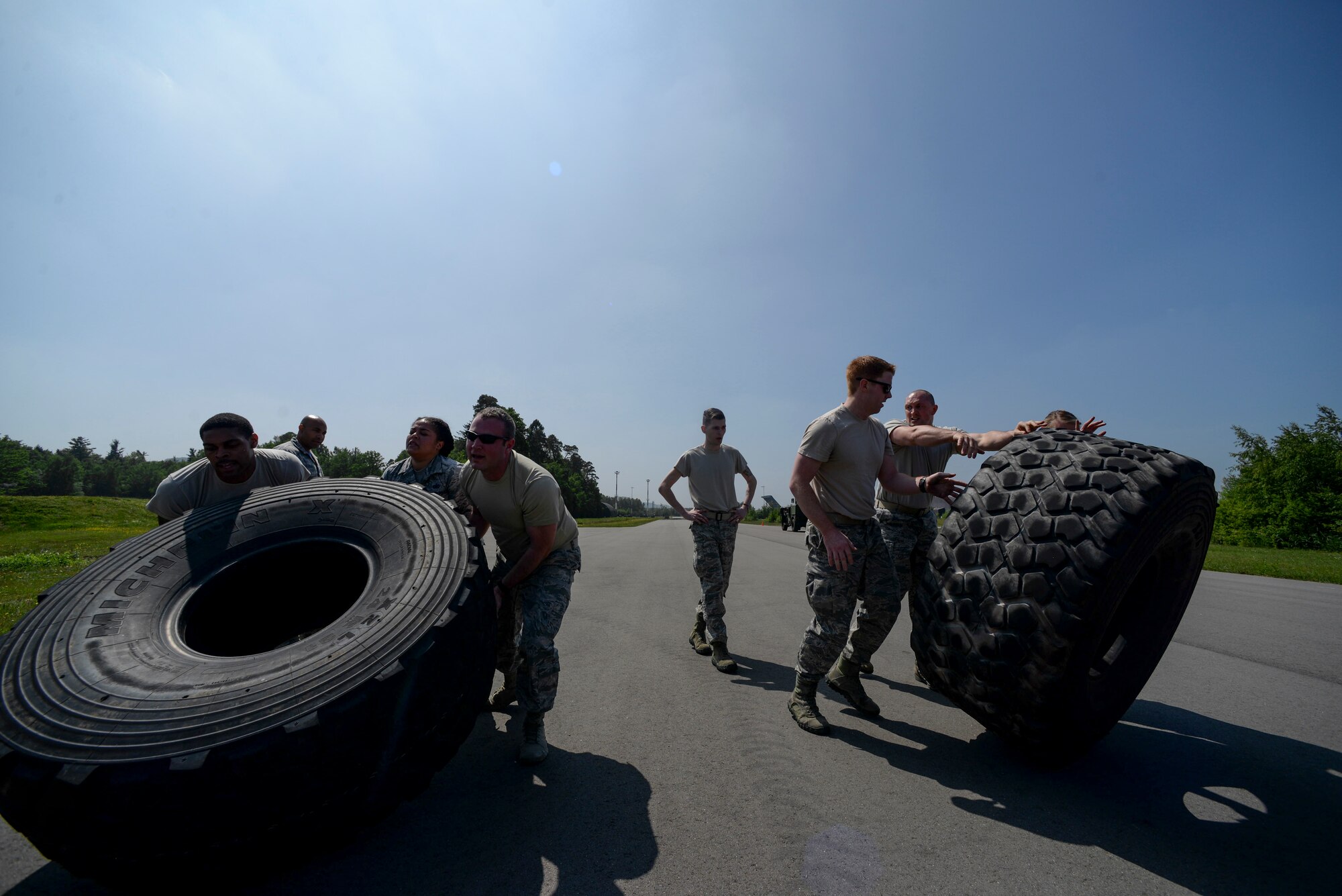 Atlantic Stripe Conference participants flip tires during an obstacle course on Ramstein Air Base, Germany, May 18, 2018. The professional development conference allowed noncommissioned officers time away from official duties to learn from leaders, mentors and guest speakers. (U.S. Air Force photo by Airman 1st Class D. Blake Browning)
