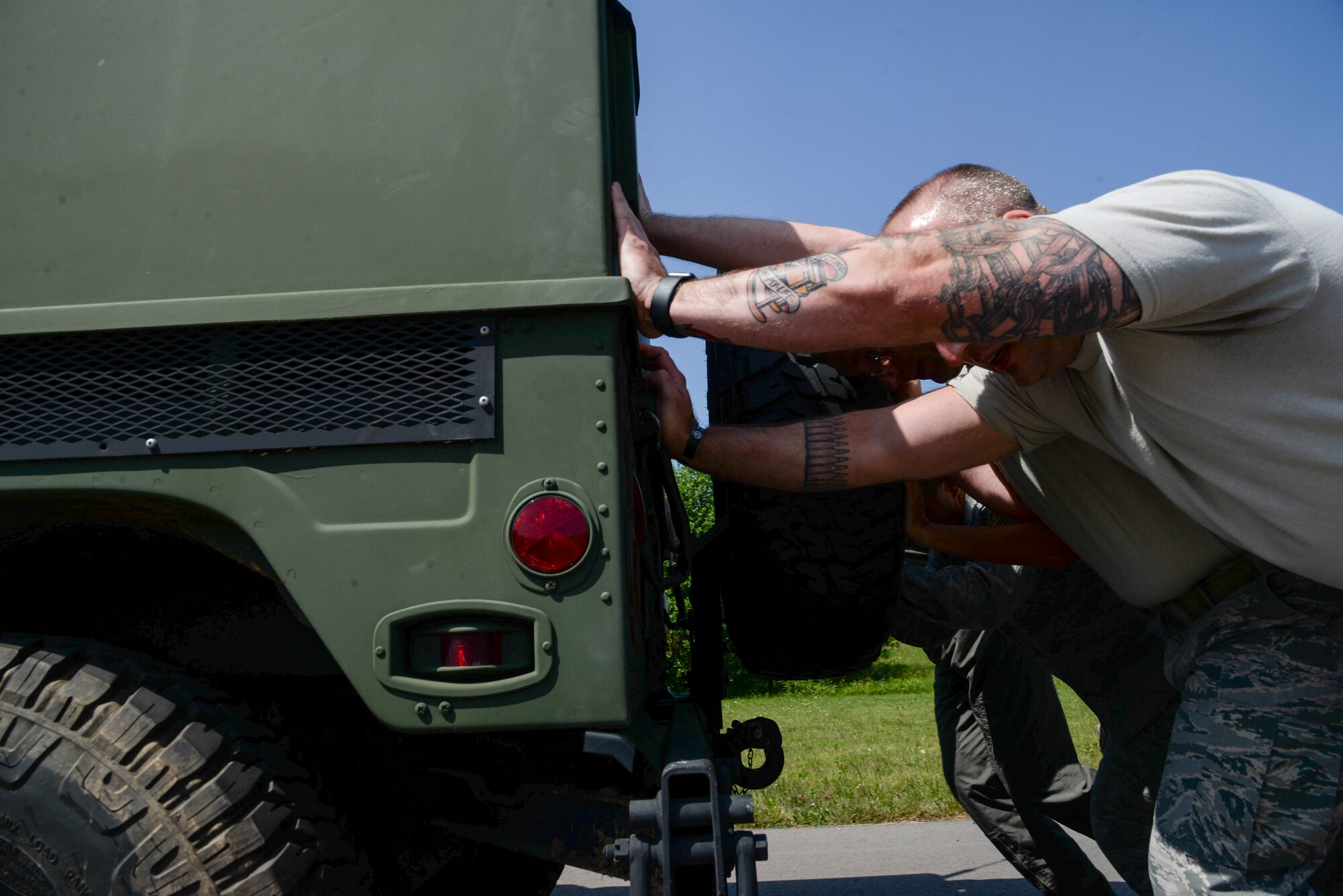 Atlantic Stripe Conference participants push a humvee as part of an obstacle course on Ramstein Air Base, Germany, May 18, 2018. The obstacle course capped off the week-long conference aimed at deliberately developing noncommissioned officers. (U.S. Air Force photo by Airman 1st Class D. Blake Browning)