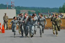 Atlantic Stripe Conference participants perform a log carry as part of an obstacle course on Ramstein Air Base, Germany, May 18, 2018. The Airmen were selected to attend the conference due to their potential to serve in higher leadership positions as they continue throughout their careers. (U.S. Air Force photo by Airman 1st Class D. Blake Browning)