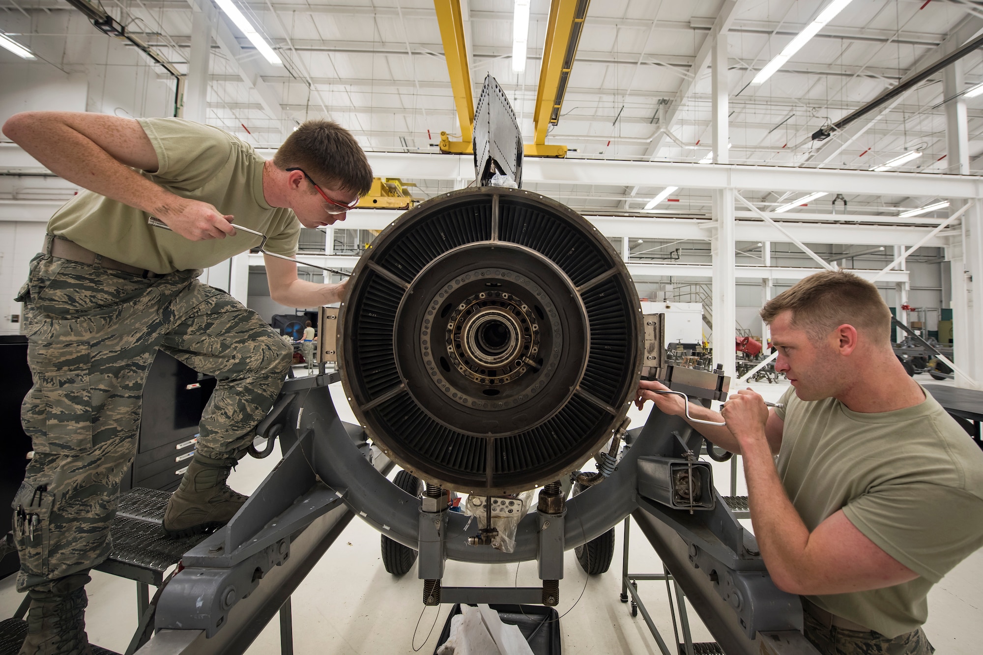 Airman 1st Class Austin Maurer, right, and Airman 1st Class Blain Gehrett, 23d Maintenance Squadron (MXS) aerospace propulsion technicians, repair a Turbo-Fan(TF)-34 engine, May 16, 2018, at Moody Air Force Base, Ga. The 23d MXS propulsion flight’s mission is to ensure that the A-10C Thunderbolt II TF-34 engine is in satisfactory condition before it’s even installed on the aircraft. This flight is responsible for the overall upkeep and maintenance of all TF-34 engines for the Air Force’s largest operational A-10 fighter group. (U.S. Air Force photo by Airman 1st Class Eugene Oliver)