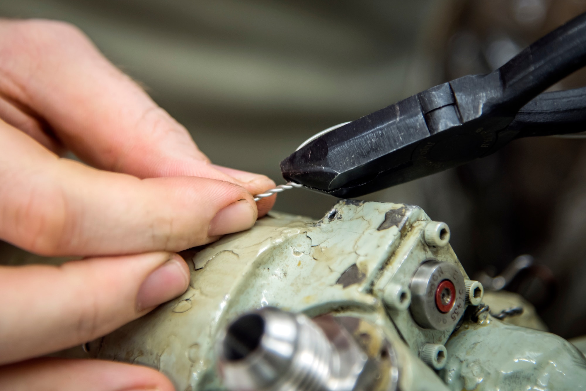 An Airman from the 23d Maintenance Squadron (MXS) ties a wire to a Turbo-Fan (TF)-34 engine, May 16, 2018, at Moody Air Force Base, Ga. The 23d MXS propulsion flight’s mission is to ensure that the A-10C Thunderbolt II TF-34 engine is in satisfactory condition before it’s even installed on the aircraft. This flight is responsible for the overall upkeep and maintenance of all TF-34 engines for the Air Force’s largest operational A-10 fighter group. (U.S. Air Force Base photo by Airman 1st Class Eugene Oliver)