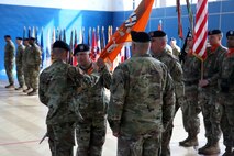 Soldiers passing unit flag
