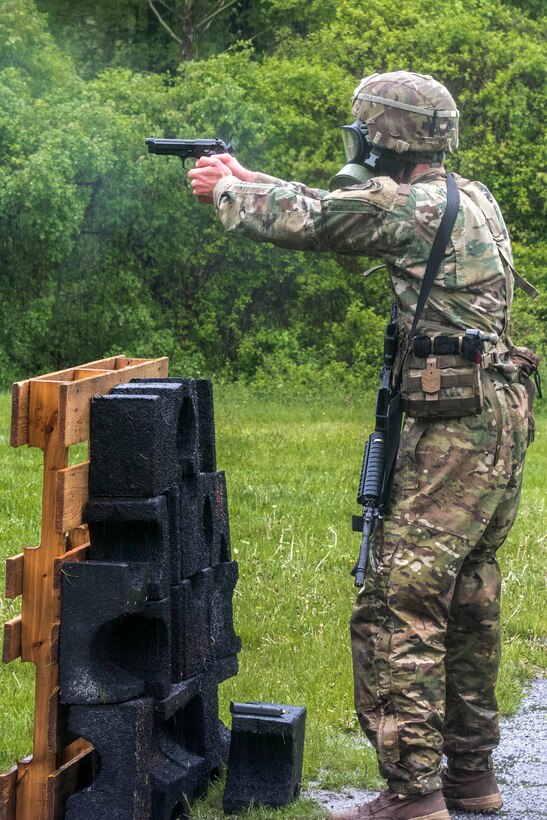 A soldier fires an M9 pistol while competing in the stress shoot event.