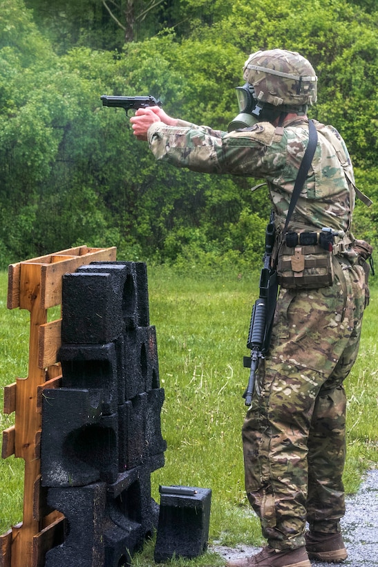 A soldier fires an M9 pistol while competing in the stress shoot event.