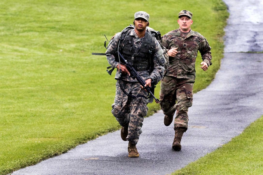 Army soldiers run during 12-mile ruck march.