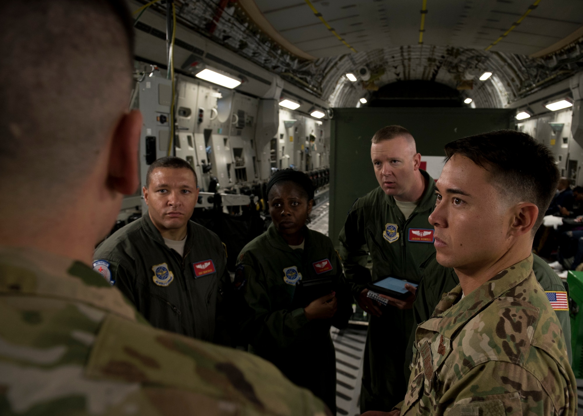 Tech. Sgt. John Brenden, 21st Airlift Squadron loadmaster, briefs aeromedics from the 375th Aeromedical Evacuation Squadron and Capt. Kai Yamashiro, 21st AS C-17 Globemaster III pilot, on egress procedures and his load plan at Travis Air Force Base, Calif., May 13, 2018. A 21st AS C-17 embarked on an AE mission supporting aerial transport of patients at various military bases in the Pacific. (U.S. Air Force photo by Lan Kim)