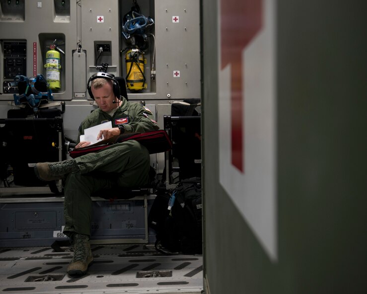 Capt. Jason Howell, 375th Aeromedical Evacuation Squadron medical crew director, reviews mission details of an AE mission in a C-17 Globemaster III at Travis Air Force Base, Calif., May 13, 2018. A 21st AS C-17 embarked on an AE mission supporting aerial transport of patients at various Air Force bases in the Pacific. (U.S. Air Force photo by Lan Kim)