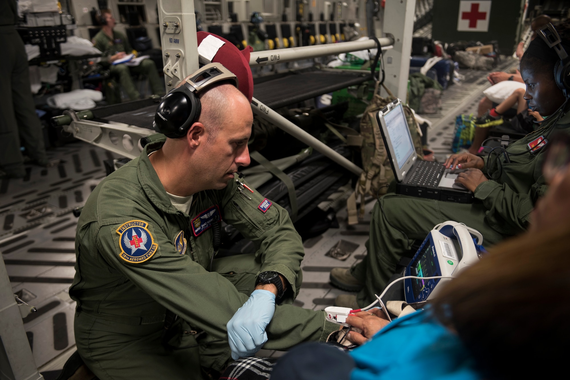 Senior Master Sgt. Brad Markwood, 18th Aeromedical Evacuation Squadron 2nd AE technician, checks the vitals of a patient on board a C-17 Globemaster III from Travis Air Force Base, Calif., May 16, 2018, at Anderson Air Force Base, Guam. AE teams provide and sustain critical care in the air for military members and their families as they travel to follow-on medical treatment facilities for medical care. (U.S. Air Force photo by Lan Kim)